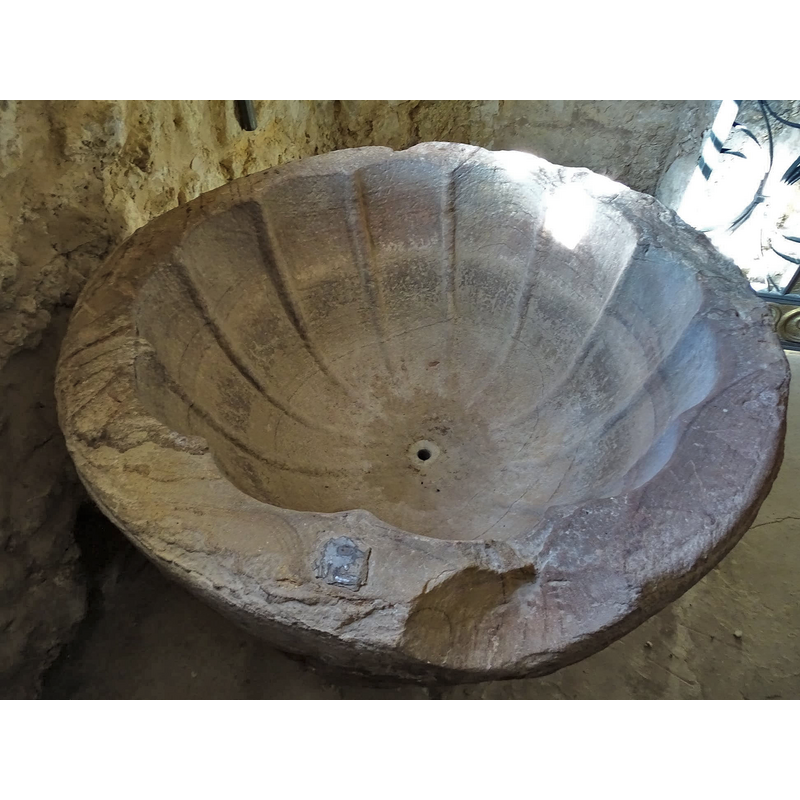 showing the centre drain hole, the inner concave ribbing and several areas of damage