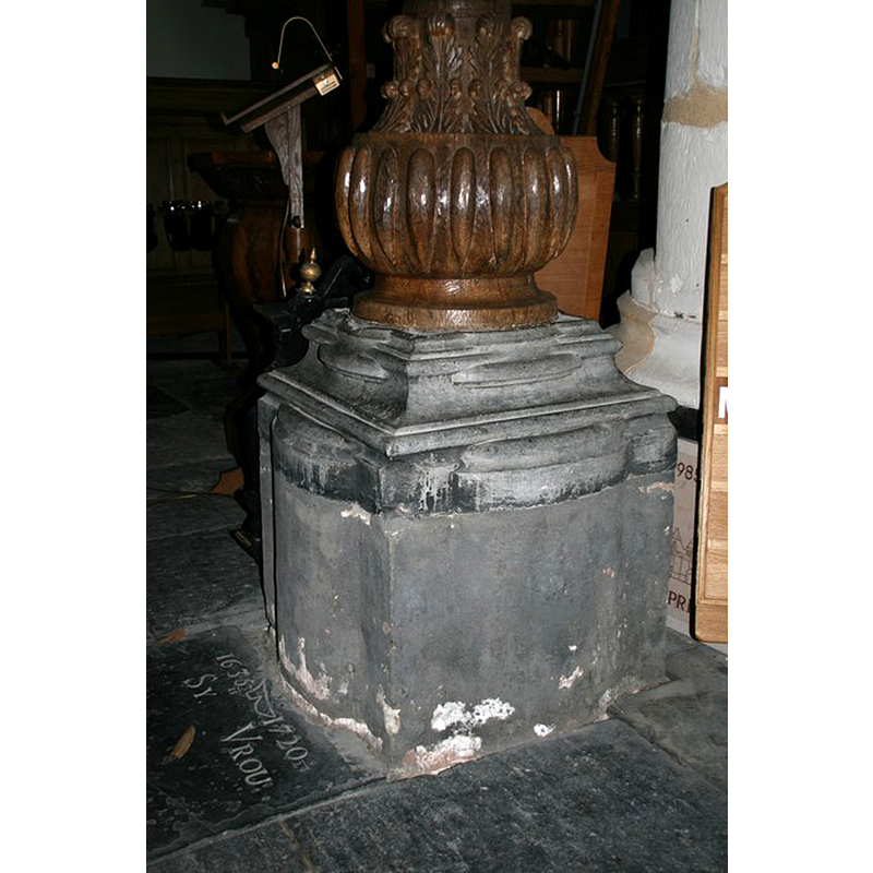 the base of the pulpit, as it was before the restoration, showing the re-cycled baptismal font lower base between the wooden upper section and the lower concrete cube
