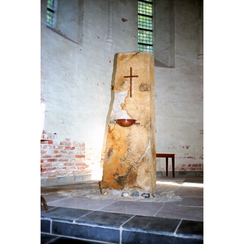 a former coffin now transformed into a baptismal font; the side with the metal basin facing west is the outer bottom of the former coffin