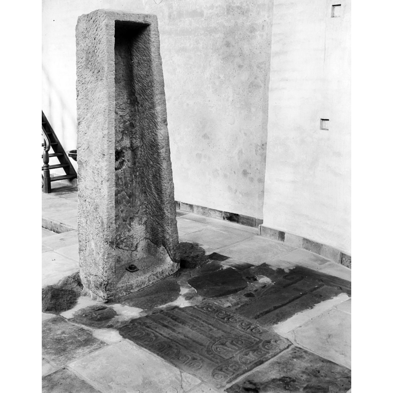 a former coffin now transformed into a baptismal font; the side facing east shows the inside of the former coffin