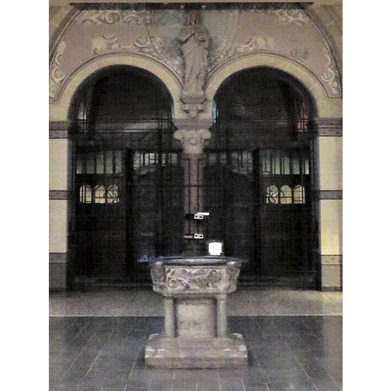 the medieval font at the west end of the nave of the 19thC church