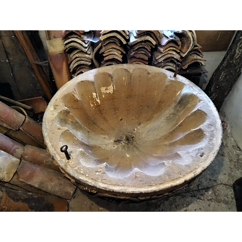 showing the central drain and the metal anchoring staples for the cover