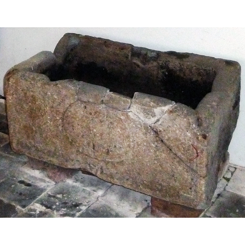 claimed to be an old baptismal font re-used as a cooling vat in a forge