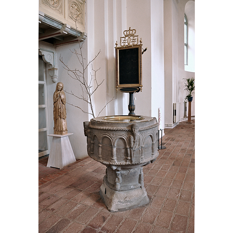 the font has been moved several times between the north and south side of the chancel of the new church