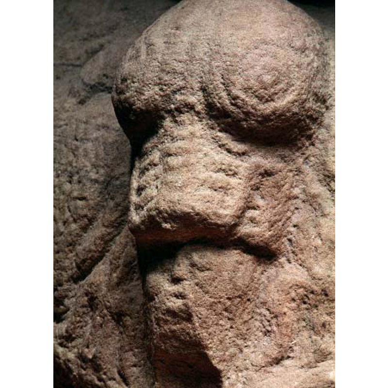 although damaged the hsape of the human head is still discernible in the beast's maw