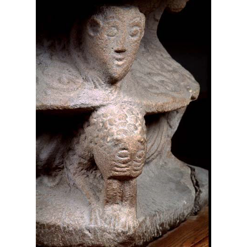 one of four heads in the corners of the upper section of the base; this one is human but the others may be animal