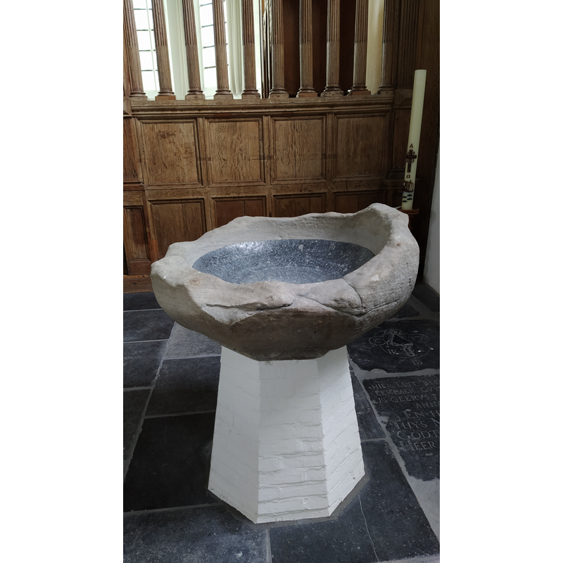 the fragment of the original font now mounted on a modern pedestal base