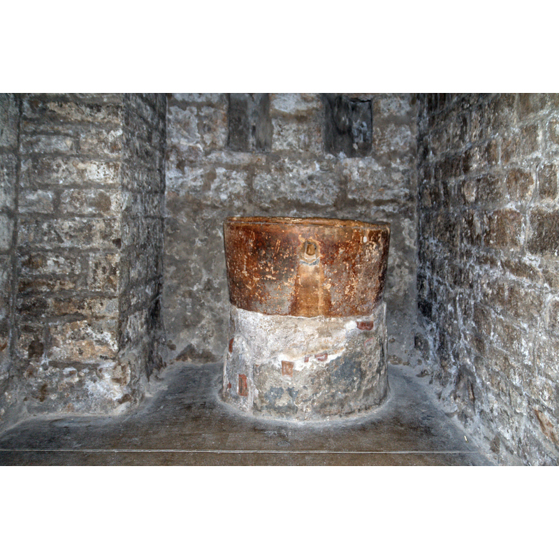 Source caption: "Terracotta baptismal font placed on a support of stones masoned in the 17th century to form a baptismal font"