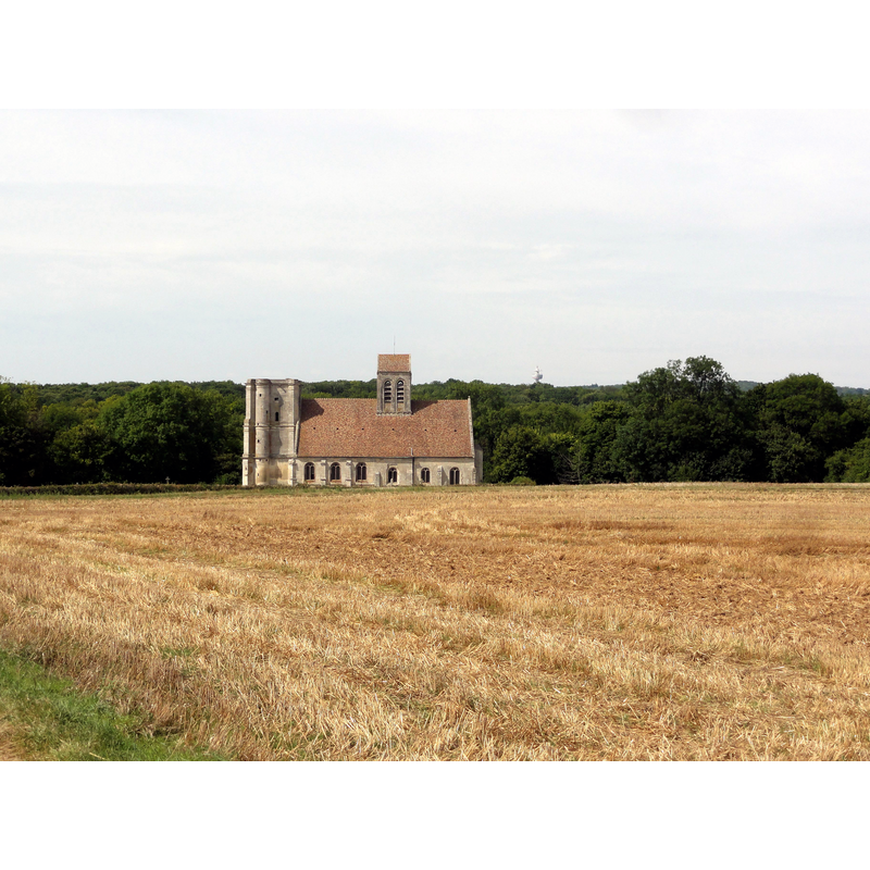 Source caption: "Vue depuis le sud." -- the church is almost 1 km from the core of the village