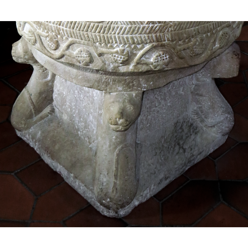tail wrapped on the hind-quarters [NB: the head on the right was damaged and has been poorly re-carved
