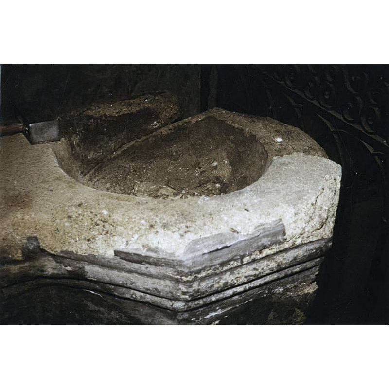the larger basin usually holds the holy-water por the baptism; it does not have a drain normally -- badly damaged and crudely repaired in part