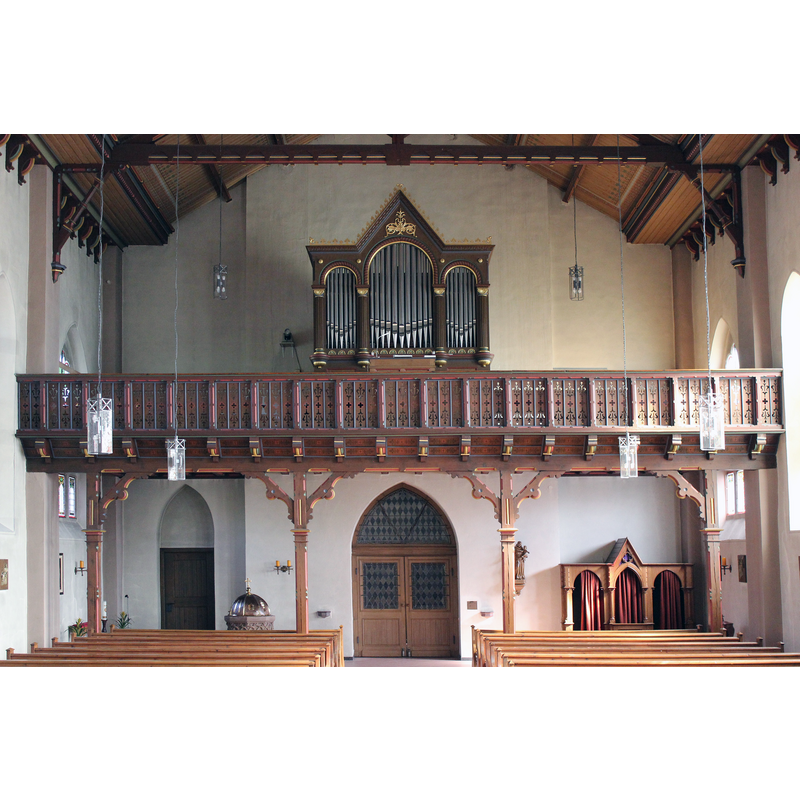 Source caption: "Katholische Kirche St. Amandus in Ottersheim (Donnersbergkreis): Blick auf die Orgelempore" -- partial view of the font and its cover at the back, between the two doors