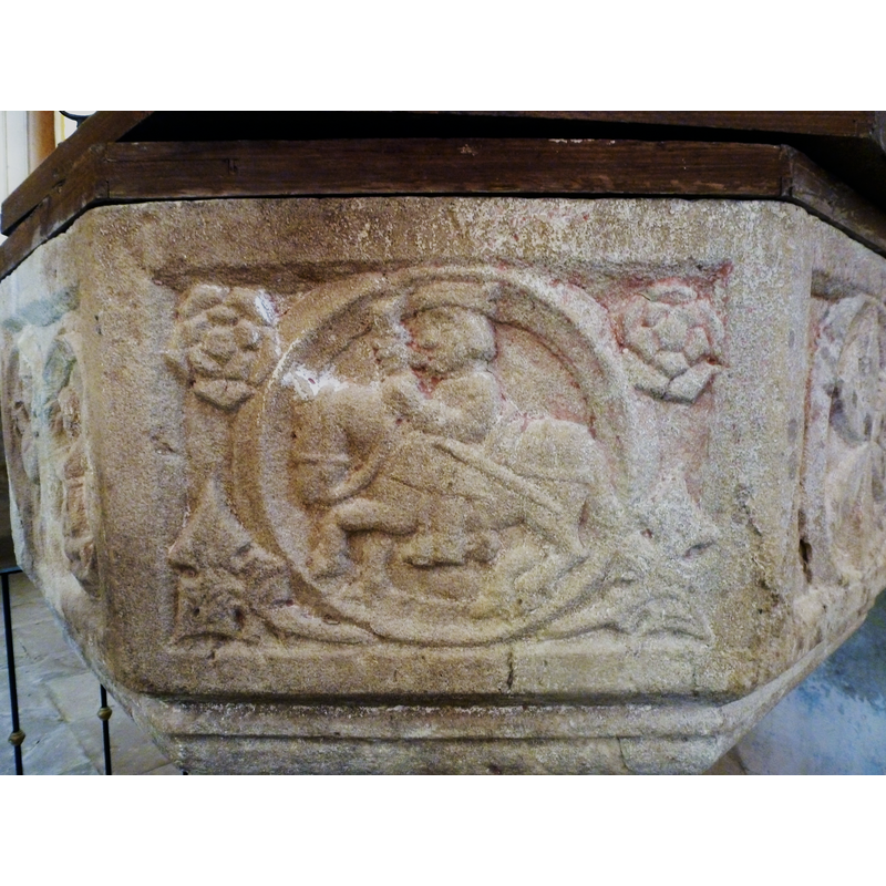 the two in the upper corners are roses; the two in the bottom corners are large leaves, similar in design to the foliated crosses on the other panels
