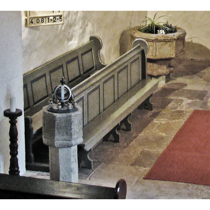 the disused 1511 font seen here at the northeat corner of the chancel, used as decorative planter; the font in the foreground  is the 1662 font in use