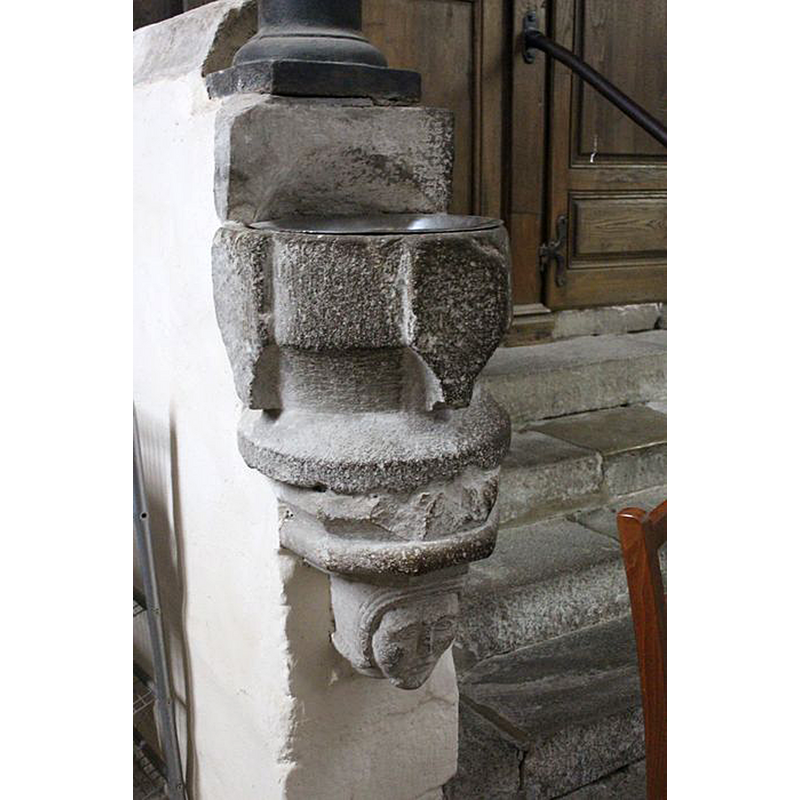 one of a pair wall-mounted by the entranceway; female head? [cf. FontNotes]
