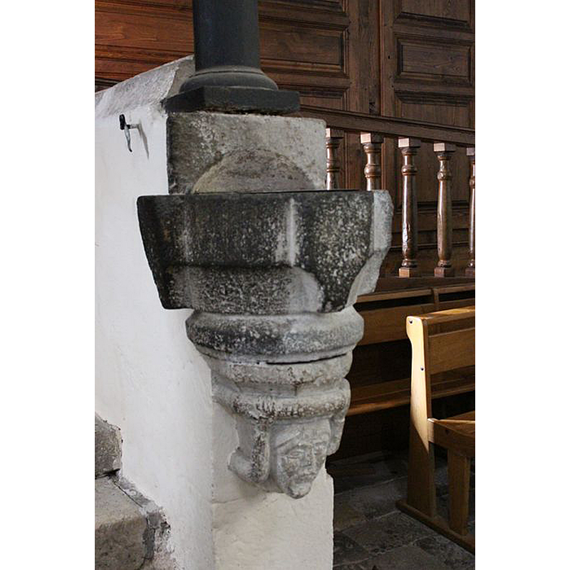 one of a pair wall-mounted by the entranceway; male head? [cf. FontNotes]