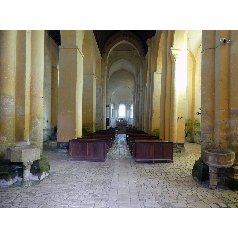 Source caption: " nef principale et choeur" -- notice the two [composite?] stoups, foreground, left and right