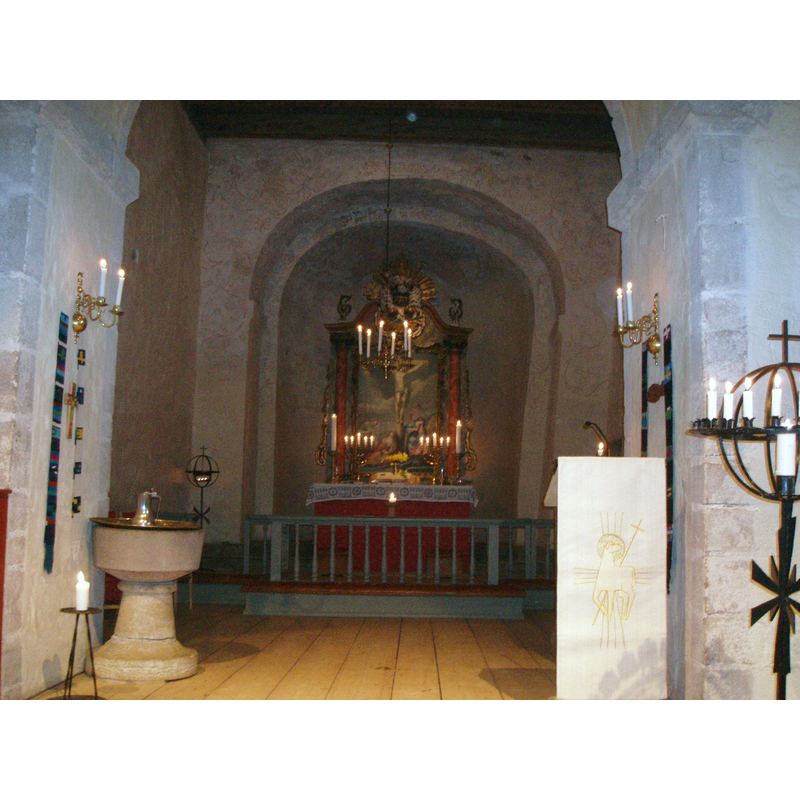 the medieval font stands by the north pillar of the chancel arch