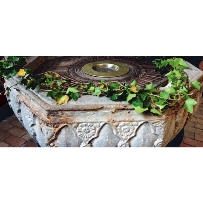 the medieval font now uses a baptismal dish supported by an internal metal grill