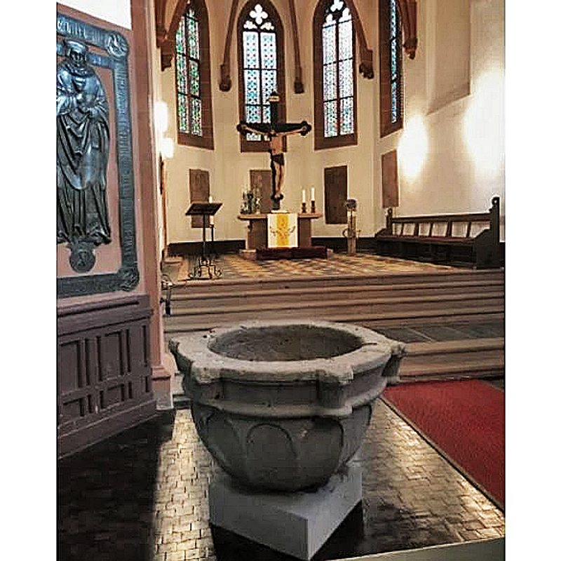 the medieival font restored to its place inside the church