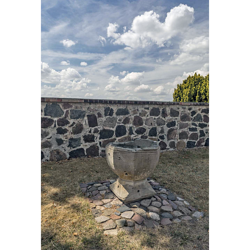 the old font in its new location outside the church