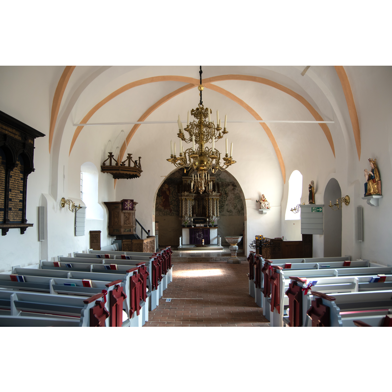 Source caption: "Waabs in Schleswig-Holstein. Die Kirche in Kleinwaabs, einem Ortsteil von Waabs steht unter Denkmalschutz." -- after the restoration; the later font at the far [east] end, on the right [east]