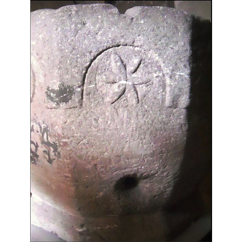 some have identified it as a star; the large side hole may have been made to drain the vessel when it was used as planter in the garden [cf. FontNotes]