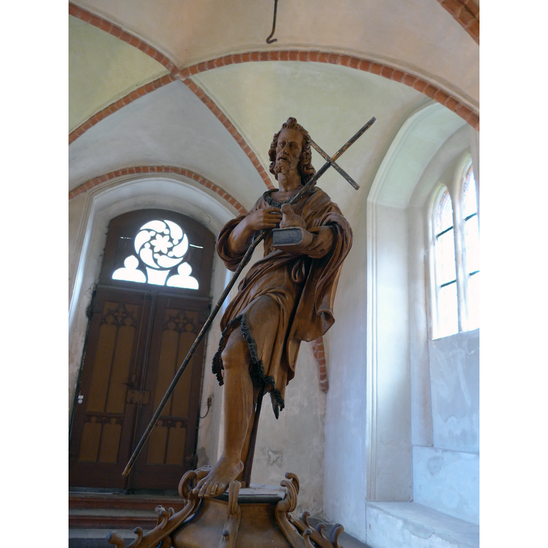Source caption: "Wittstock, Marienkirche Taufdeckel, Johannes der Täufer, 1634" -- notice the metal hook above the head of the Baptist; it is not connected to the cover now but it is part of the pulley system used earlier to raise the cover; it connected to a loop on the Baptist shoulder