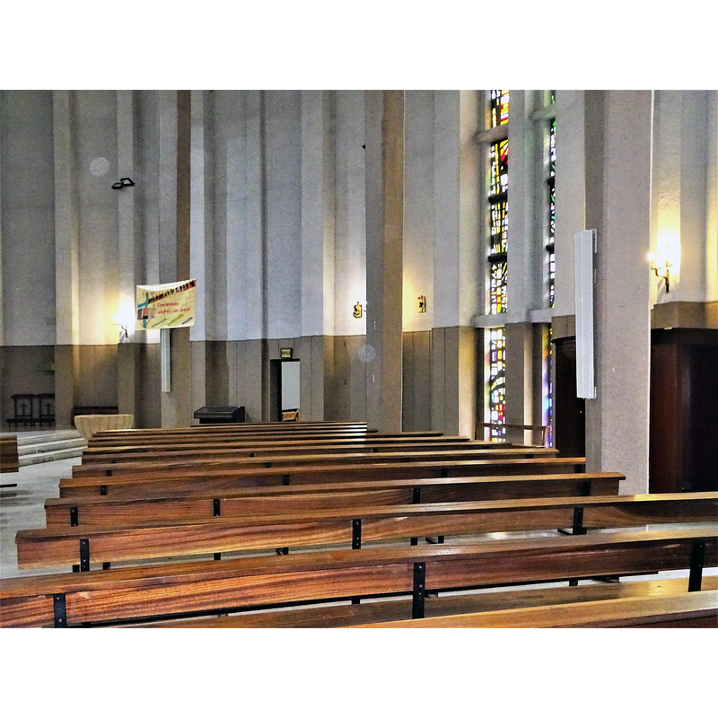 the medieval font is partially visible on the left, in the church built in 1969