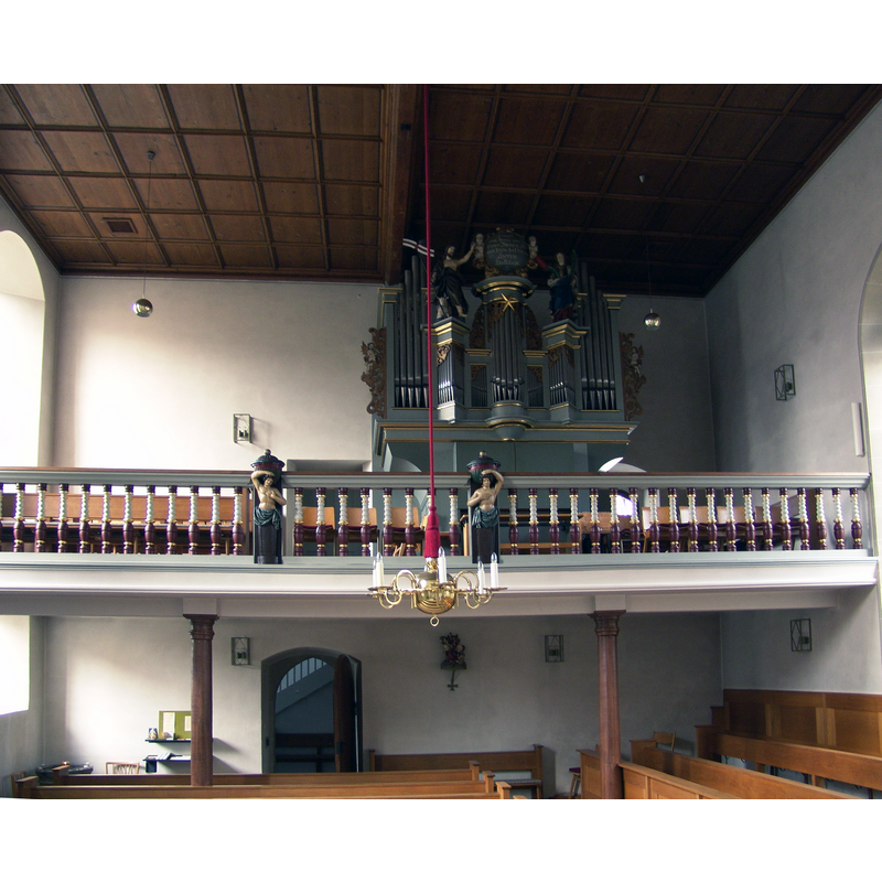 Source caption: "evang.-luth. Kirche St. Martin in Segnitz" -- the top of the old font is partially visible here in the bottom-left corner of the image; it is not used for baptisms but as a light-corner at the southwest corner of the nave, beneath the gallery