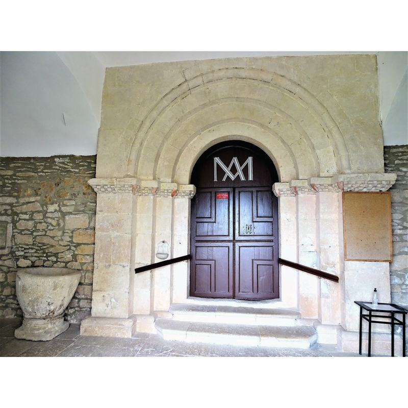 the baptismal font originally from Relloso shown here at the entrance of the church in Quincoces de Yuso