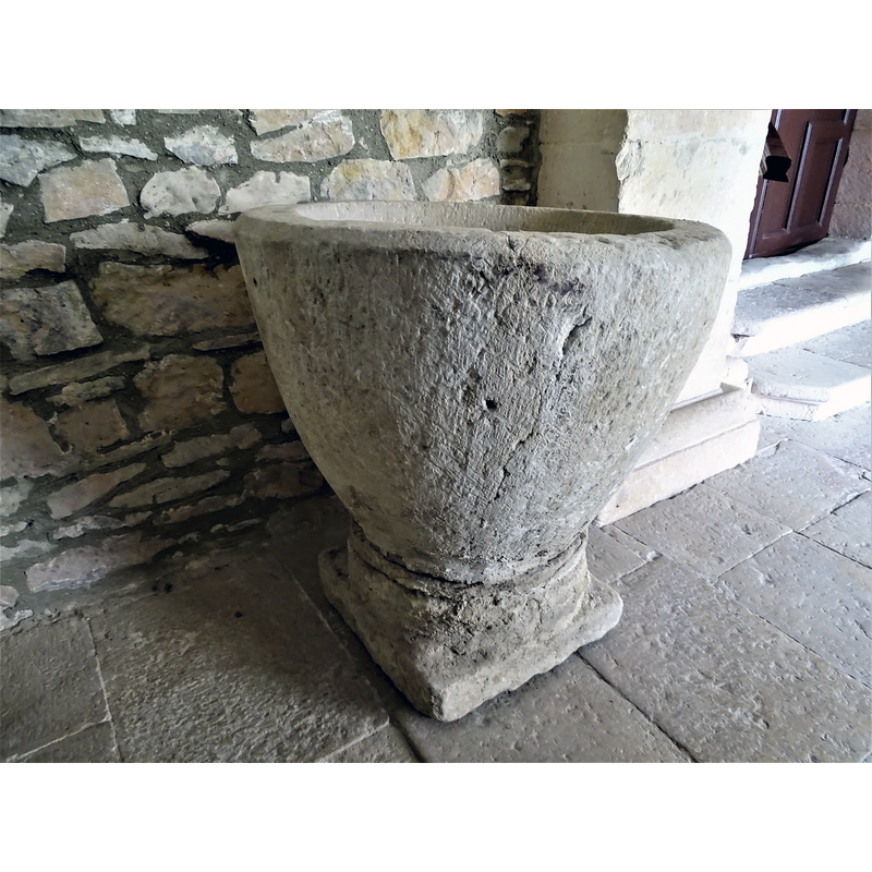 the baptismal font originally from Relloso shown here at the entrance of the church in Quincoces de Yuso