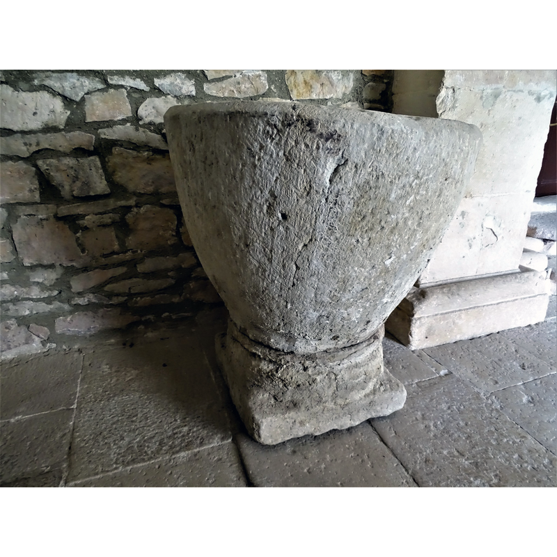 the baptismal font originally from Relloso shown here at the entrance of the church in Quincoces de Yuso