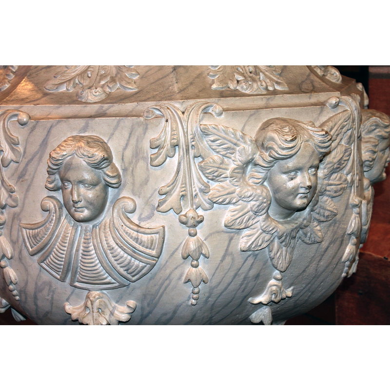 some are angel's heads, with wings showing; others are not; the pattern below the head on the left here suggests a bib, perhaps a clerical one