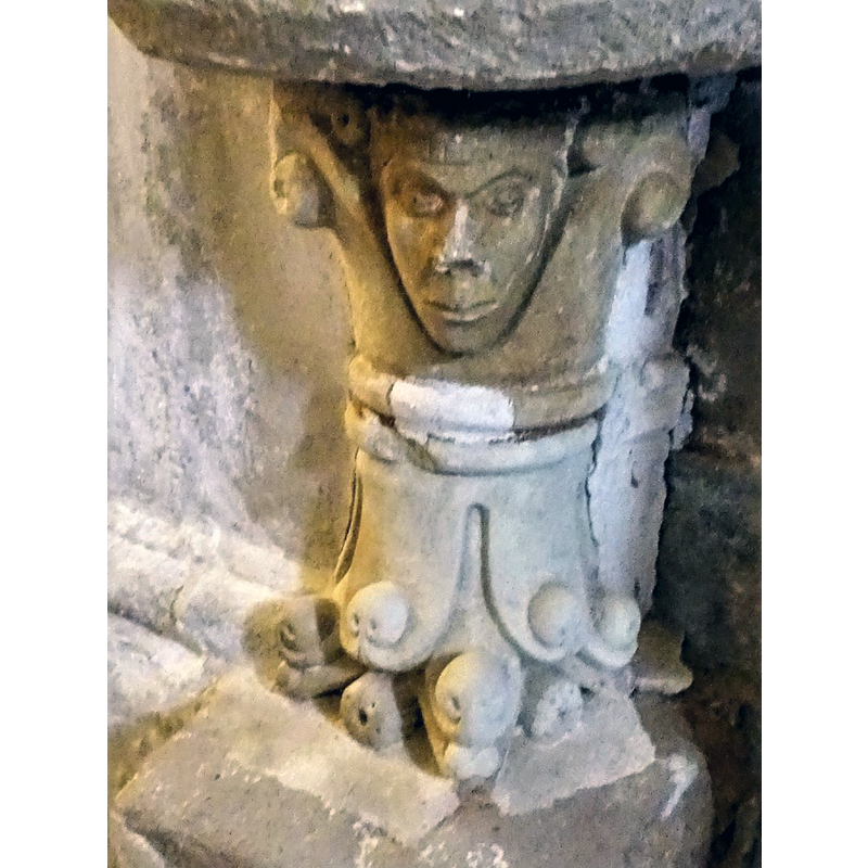the two capitals that make up the pedestal base of the stoup