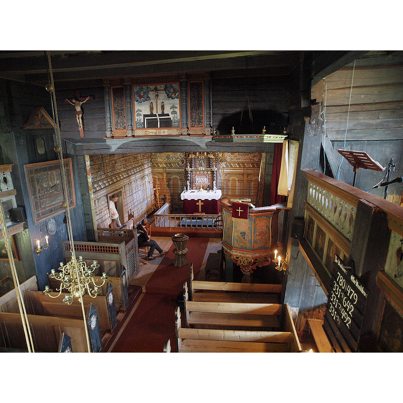 showing the wooden font and its metal baptismal dish in the centre of the image