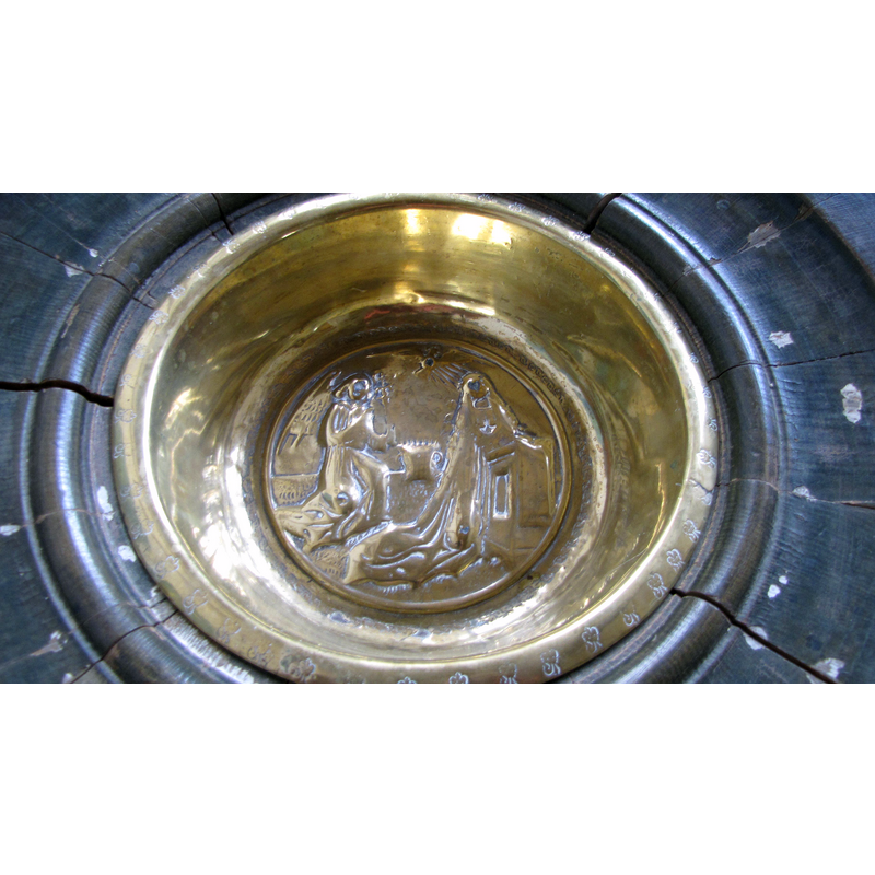 Source caption: "Gothic brass Baptismal bowl in St. Laurentius (Schönberg) showing the Annunciation"
