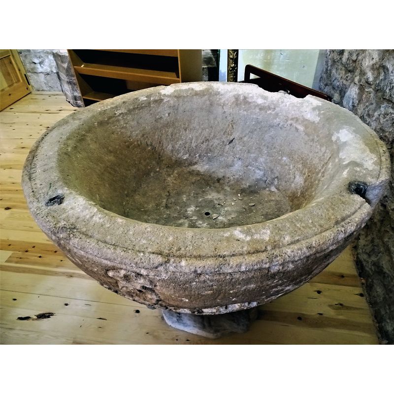 showing some of the damage to the upper rim area, and the metal anchorings for the cover
