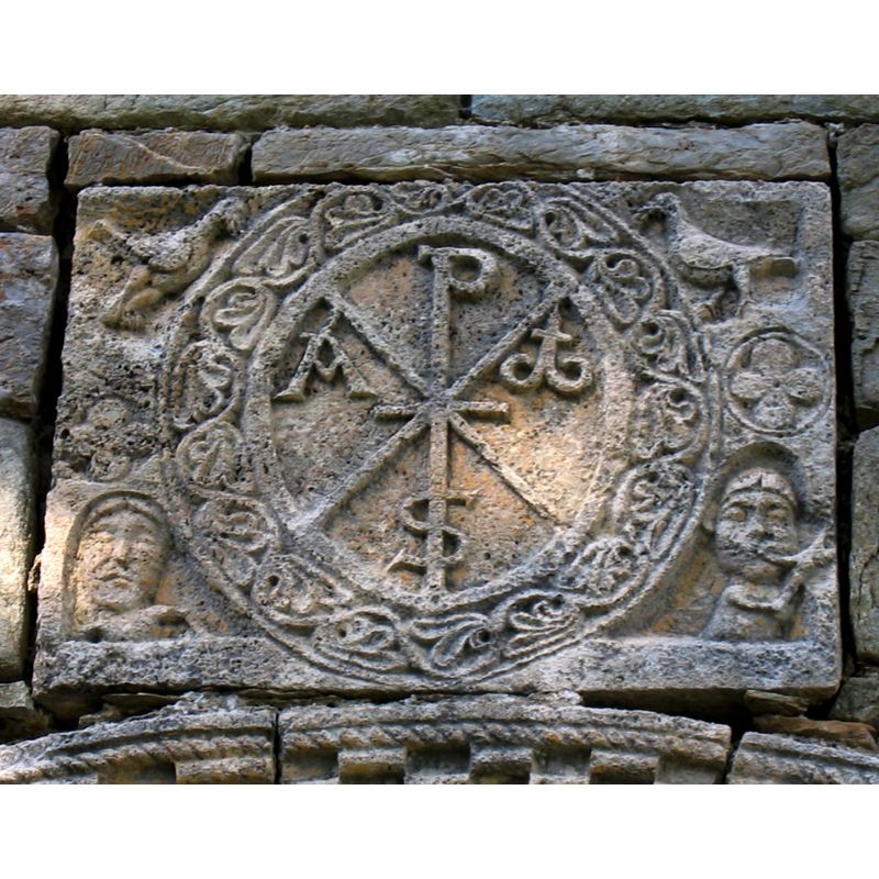 Source caption: "Chi-Rho symbol in relief (12th century), Santa Maria de Cóll church, Vall de Boí, Catalonia, Spain "