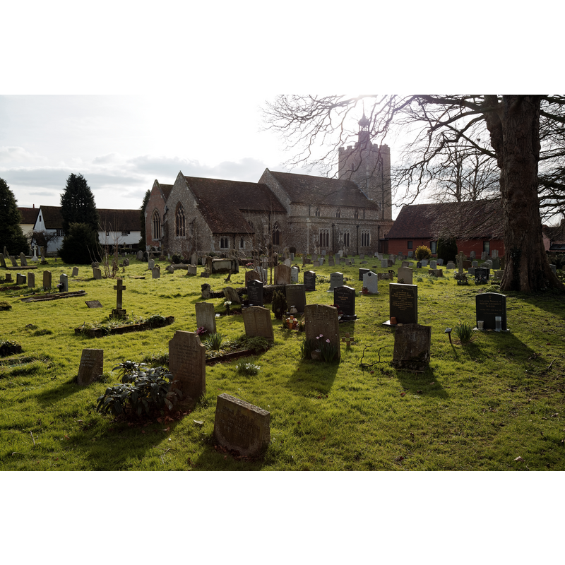 Source caption: "The north-east of the churchyard of the Grade I listed Holy Cross Church on the B1417 Braintree Road, Felsted, Essex, England."