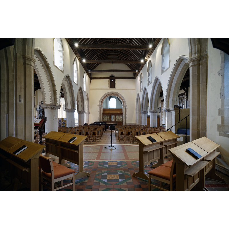 Source caption: "The chancel and nave facing west towards the tower arch of the Grade I listed Holy Cross Church on the B1417 Braintree Road, Felsted, Essex, England."