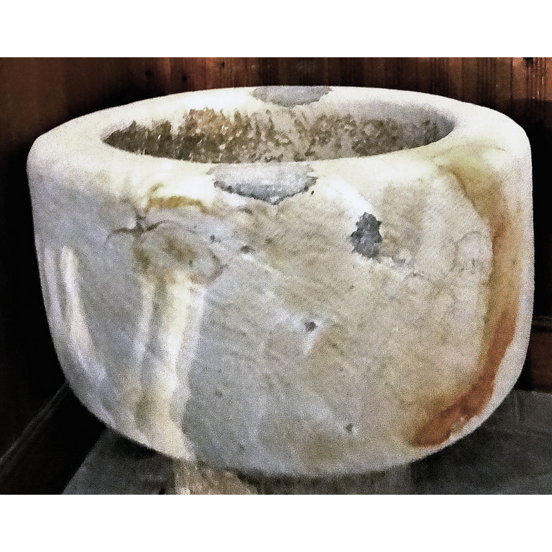 several spots of damage and repair are shown here, two of them located at opposite ends on the upper rim are obviously former anchorings for the font cover, now cemented over