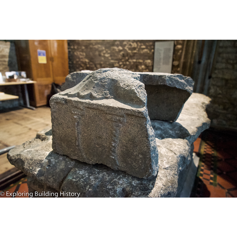 one of the stiff-leaf capitals that accommodated the top of the column of the base is seen here, on the left side of the upside-down basin -- the base probably consisted of a broad central shaft and four outer colonnettes, one of which would fit on this capital
