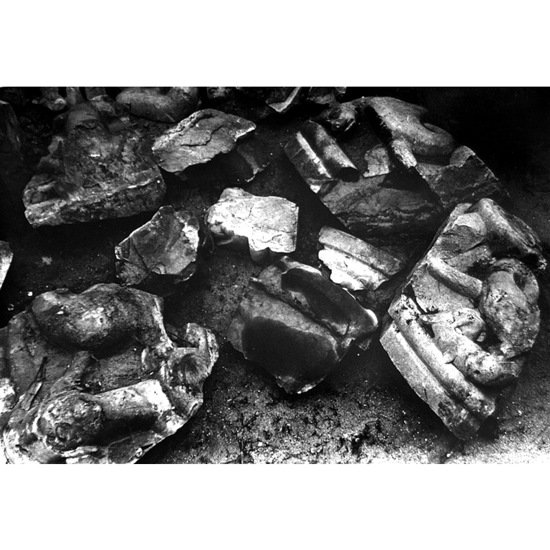 the fragments of an old limestone baptismal font, as found