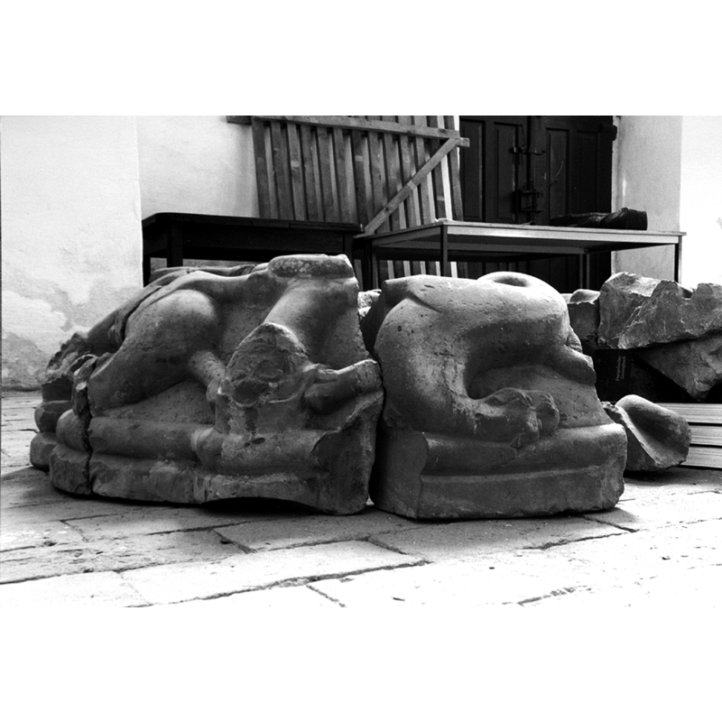 the fragments of an old limestone baptismal font, organised here in an attempt to figure the font design