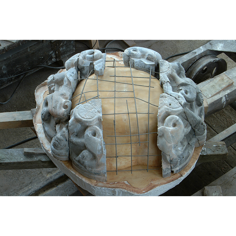 the fragments of the old limestone font arranged here during the reconstruction in Daniel Priese's workshop
