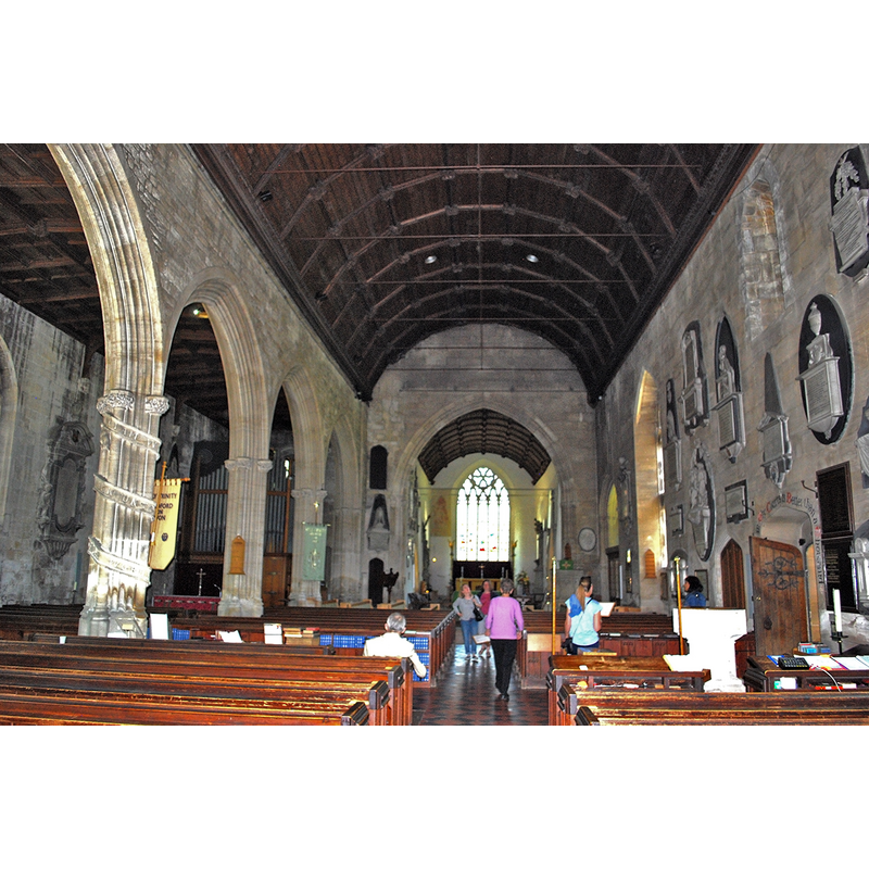 Source caption: "Built on the site of a Saxon Minster Church of c.705, Holy Trinity church was built in the 12th Century (Norman) and enlarged and refashioned in the 14th (Decorated), 15th & 16th (Perpendicular) Centuries. In the 1860's it was extensively restored and some parts rebuilt. Pictured is the Norman nave and Perpendicular north aisle, with the arcade substantially rebuilt in Victorian times." -- noticed the font and cover in the bottom-left corner of the image, by the south doorway