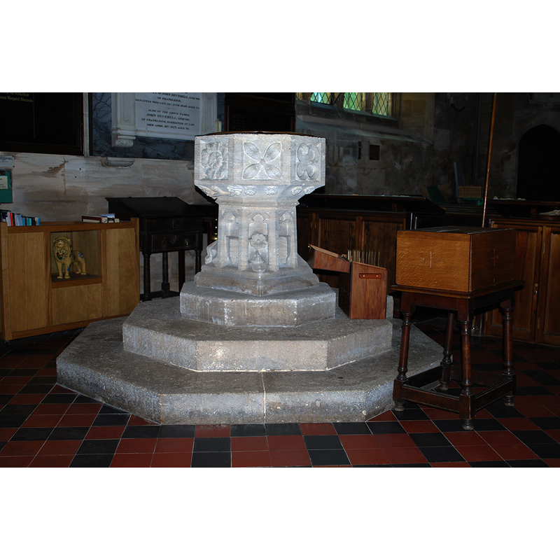 Source caption: "Bradford-on-Avon Church (Holy Trinity), Wiltshire, 19 July 2015. Pictured is the font, which seems to be Perpendicular but may be Victorian neo-Gothic." The entry for this church in Historic England [List Entry Number: 1364540] notes: "The font has a Perp octagonal bowl with unmoulded square panels, perhaps recut in the 17th century with quirky geometric patterns; the stem has cusped panels and shields."