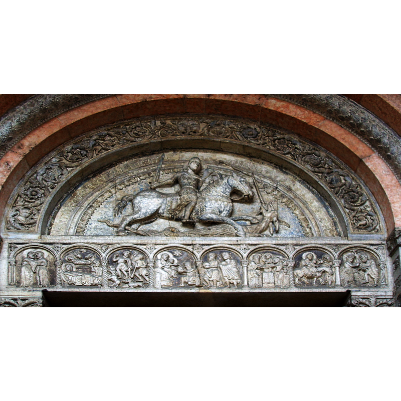 Source caption: " Lunette (showing Saint George) and architrave (showing Scenes from the New Teastament) from the main portal of the Cathedral of Ferrara, sculpted by Romanesque artist "Magister Nicholaus" (12th century)."