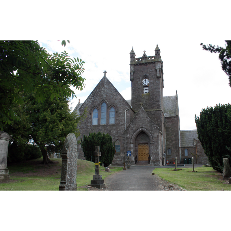 Source caption: "Meigle Church. On the site of a turf church erected by Columban missionaries around 606 AD. This building dates from 1870 AD. The previous church built in 1793 AD burned down on 28 March 1869. The church before that dated from 1431 AD. Folklore claims the mound on the left of the path to be the grave mound of Vanora (Queen Guinevere)"